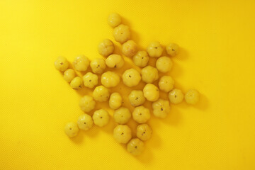 sour fruit over on yellow background