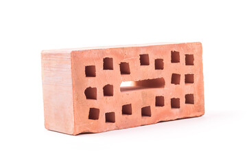 white background. the brick was made of clay. there are holes. close-up.
