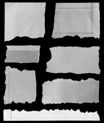 Seven pieces of torn newspaper on black background