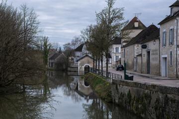 Fototapeta na wymiar Chablis, France - February 23, 2022: Chablis is a town in the Bourgogne-Franche-Comte famous for its french white wine. Cloudy winter day. Selective focus.