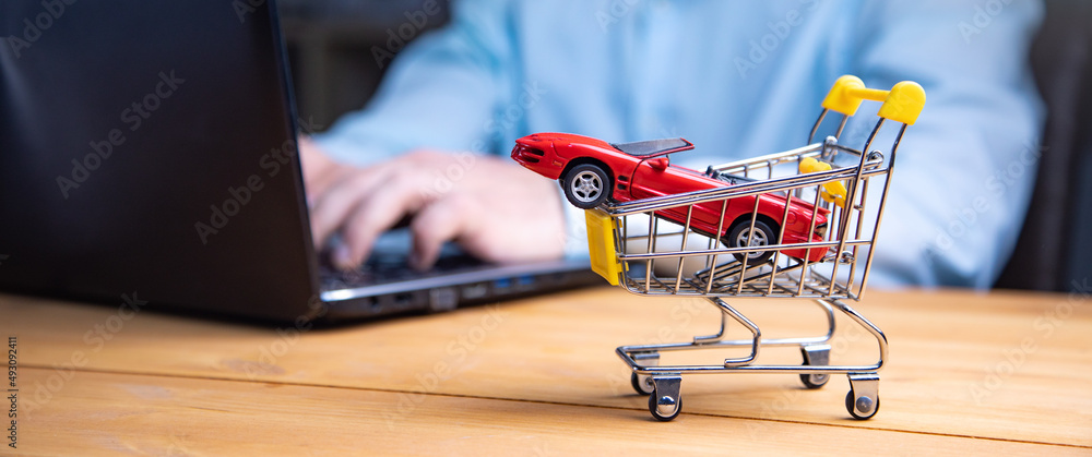 Poster man with computer and car in basket