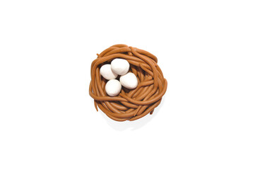 a nest with four eggs on a white background