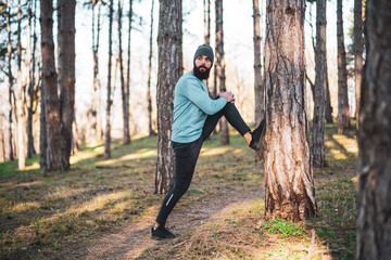 Man with beard enjoys exercising in nature.