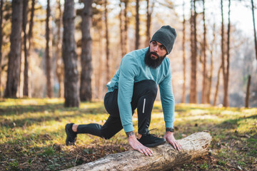 Naklejka na ściany i meble Man with beard enjoys exercising in nature.
