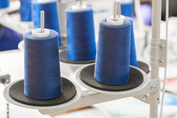 Blue reels of threads industry background, Spools of colored cotton thread, ordered composition