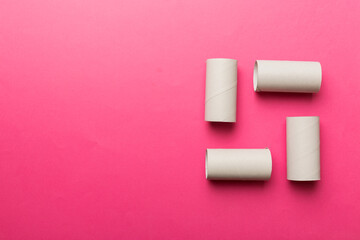 Flat lay composition with empty toilet paper rolls and space for text on color background. Recyclable paper tube with metal plug end made of kraft paper or cardboard
