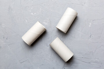 Flat lay composition with empty toilet paper rolls and space for text on color background. Recyclable paper tube with metal plug end made of kraft paper or cardboard