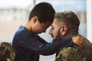 Soldier welcoming his son at home - family concepts in war -