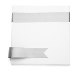 Blank board with silver ribbons on white background
