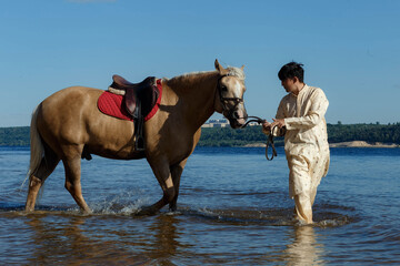 a man on a horse in the river on a sunny day