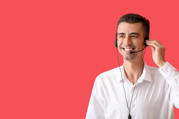 Answering male consultant of call center with headset on red background