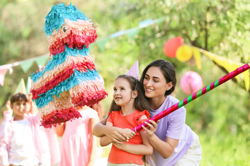 Mother and her little daughter at pinata birthday party