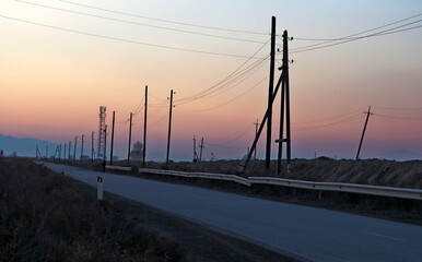 Fototapeta na wymiar electric poles accompany the road