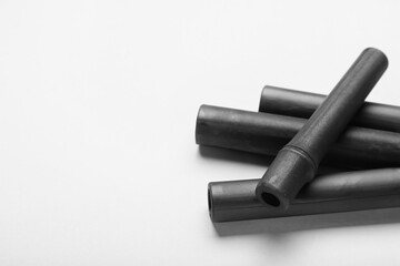 Black bamboo sticks on white background, closeup