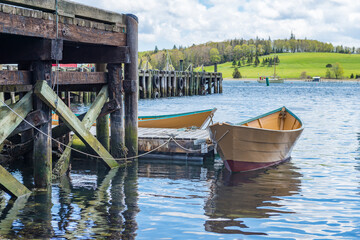 Atlantic Canada Pier with Dorys tied to the Dock in a Summer Setting