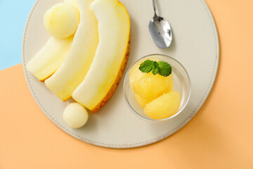Bowl with tasty sorbet and melon pieces on color background