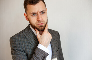 
a young man with a beard 25-35 in a suit is experiencing unpreparedness, fear, concern, deep in...
