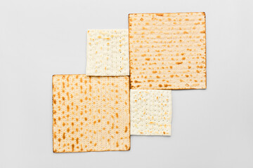 Jewish flatbread matza for Passover on light background, top view
