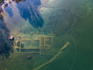 Two divers explore the remains of a church submerged in water