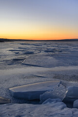 Sunset over the winter river. Frozen river