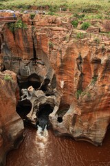 Bourke's Luck Potholes, Blyde River Canyon view to red rock formations with brown water river and some potholes
