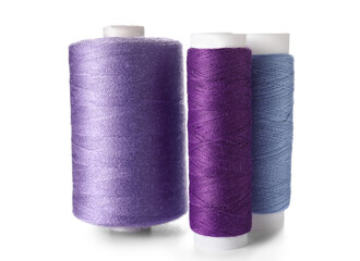 Purple sewing thread spools on white background