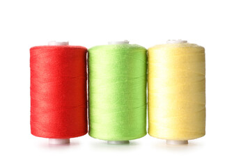 Multicolored sewing thread spools on white background