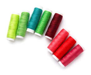 Different thread spools on white background