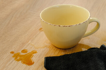 closeup of cup of coffee, tea suddenly spills, hot liquid spoils equipment, concept of need to...