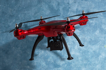radio-controlled drone with a compact video camera on a blue background.
