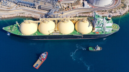 Aerial drone photo of LNG (Liquified Natural Gas) tanker anchored in small LNG industrial islet of...