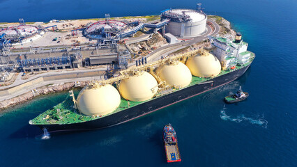Aerial drone photo of LNG (Liquified Natural Gas) tanker anchored in small gas terminal island with...