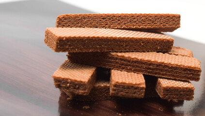 Pile of delicious chocolate wafers, on white background.