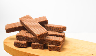 Pile of delicious chocolate wafers, on white background.