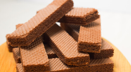 Pile of delicious chocolate wafers, on white background.
