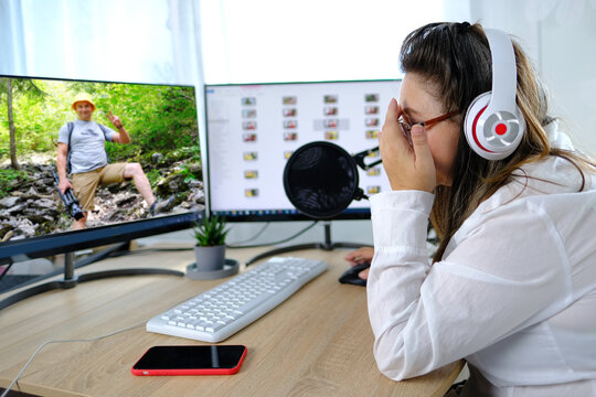 woman 40-45 years old, pretty female blogger sits in front of computer with green screen in front of microphone, emotionally talks on topic of business, communication during quarantine covid 19 - Powered by Adobe
