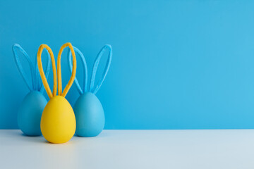 Blue and yellow Easter eggs with bunny ears, holiday decoration