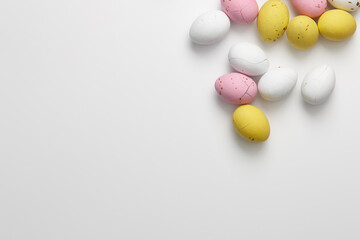 Colorful chocolate Easter candies on white background