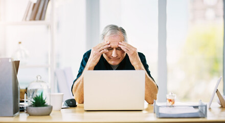 This headache isnt helping matters either. Shot of a mature businessman suffering from a headache...