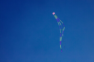Obraz na płótnie Canvas angled view of a colorful kite flying waving