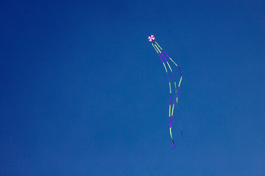 angled view of a colorful kite flying waving