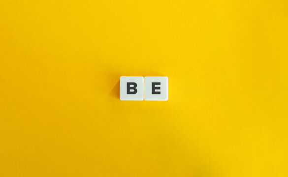 Be Word on Letter Tiles on Yellow Background. Minimal Aesthetics.