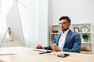 handsome businessman sitting at the computer work boss isolated background
