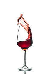 a glass of red wine in a transparent glass on a white background with reflection