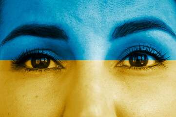 female face painted in blue-yellow color