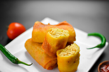 Fried Chinese traditional spring roll food on ceramic plate (beautiful shape) on black background
