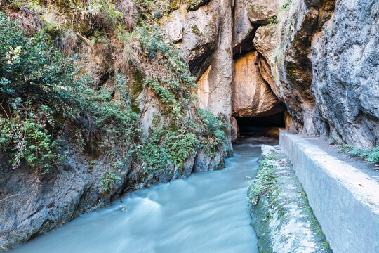 Entrance of the river in the cave between mountains in the route of the river Monachil, in Los Cahorros, Granada, Spain.