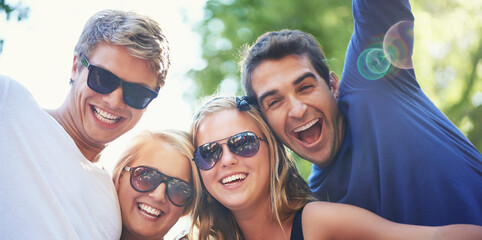 Enjoying the vibe. Four young friends cheering and enjoying each others company at a music festival.