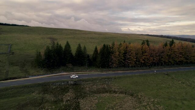 Car Moving on Road in French Lowland by Drone