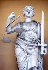 Goddess of justice with sword and scales in her hands.